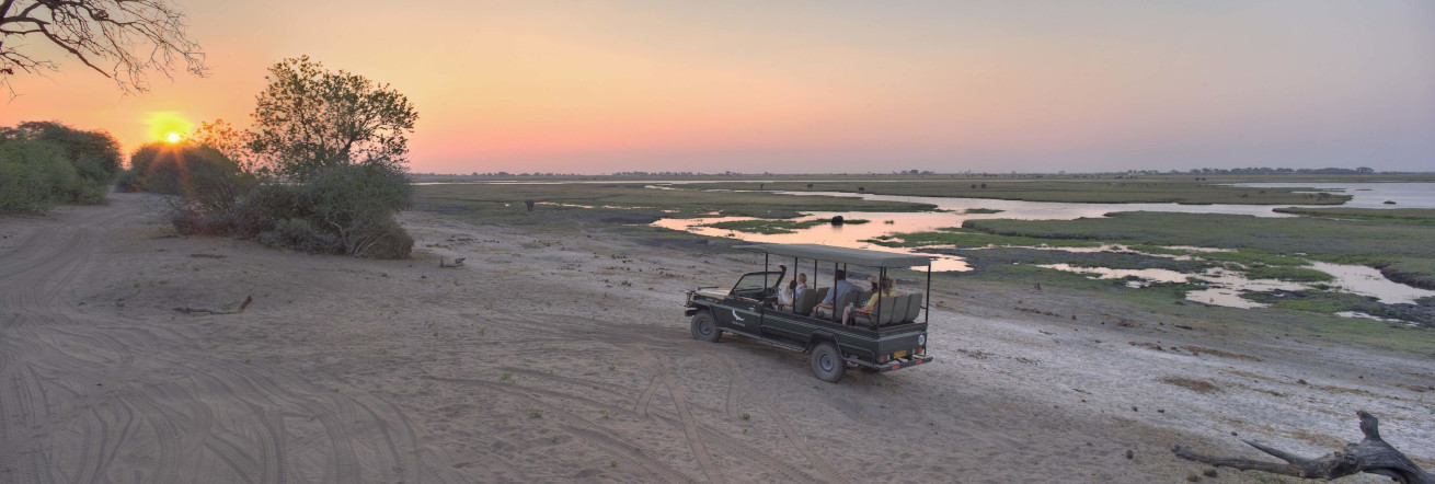 Sundowners on the banks of the Chobe River, andBeyond Chobe Under Canvas