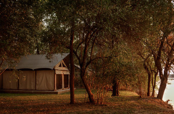  Relax and watch the river slip by from your tent at Luambe Camp