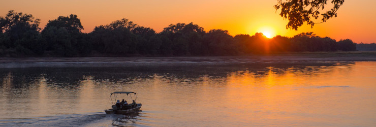 Cruise along the Luangwa River at sunset