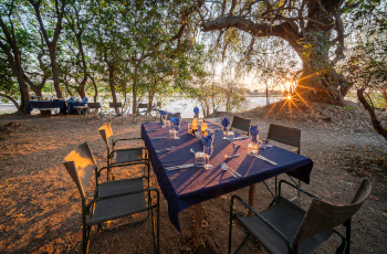  Dine under the trees on the banks of the Luangwa River