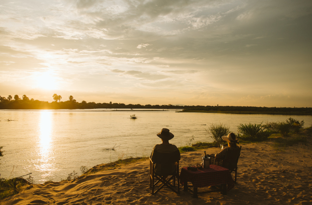 Sundowners overlooking the Nyerere Nationa Park, Rufiji River Camp