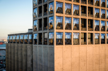 The sun's reflection of the grand windows at The Silo Hotel