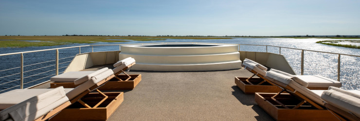  Relax on the pool deck looking out over the Chobe National Park