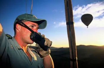 Hot air balloon pilot in flight over the Pilanesberg