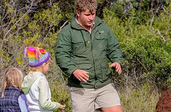 A safari guide engaging with children, Kariega Game Reserve