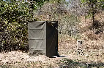 Pit latrine toilets and bucket showers at your mobile camp