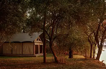 Relax and watch the river slip by from your tent at Luambe Camp