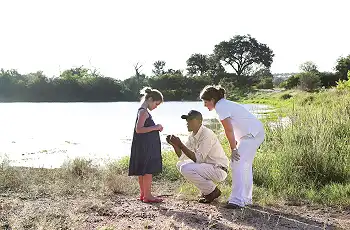 Bush interpretation by a safari guide for a child, Londolozi Game Reserve