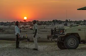 Sundowners during a game drive at Le Roo La Tau, Botswana