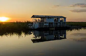 Sunset along the river onboard the Okavango Spirit